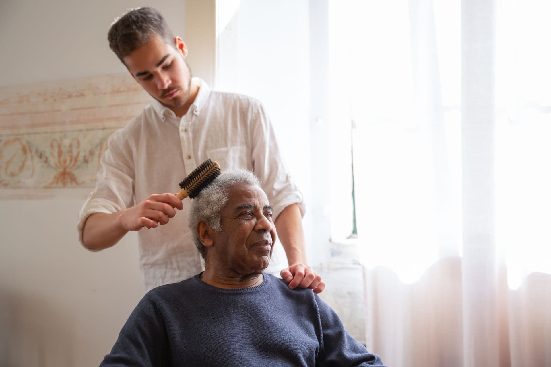 Caregiver providing comfort to elderly patient