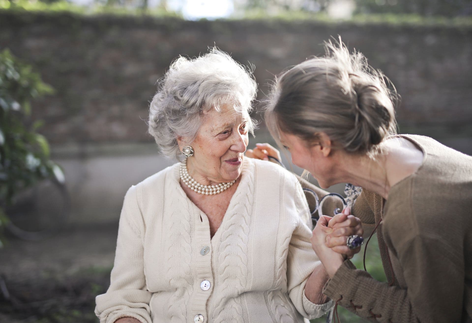 Happy elderly person smiling in a bright, clean home