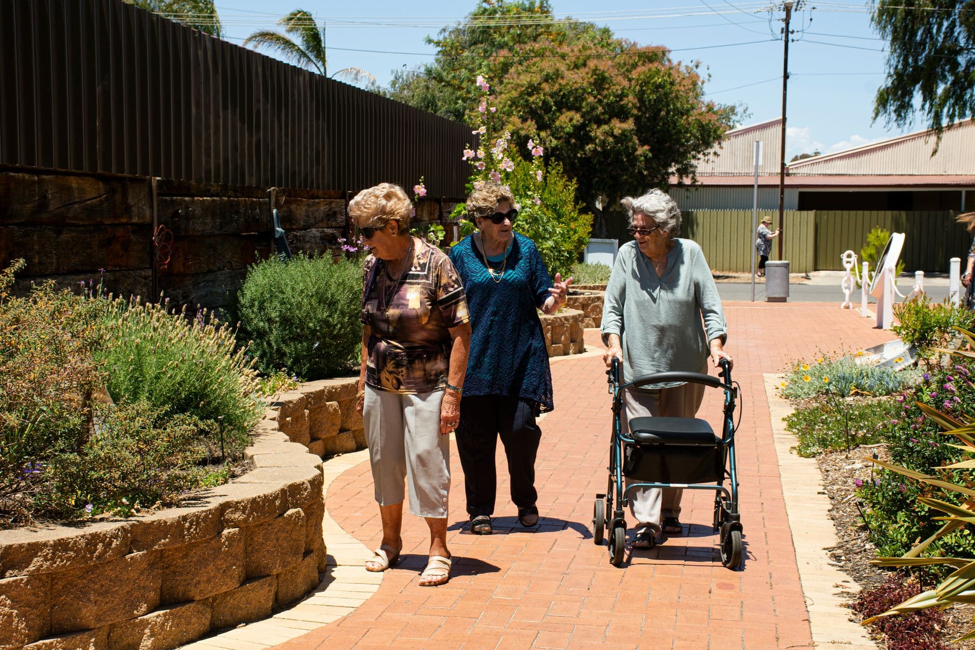 Caregiver helping client into vehicle for transportation